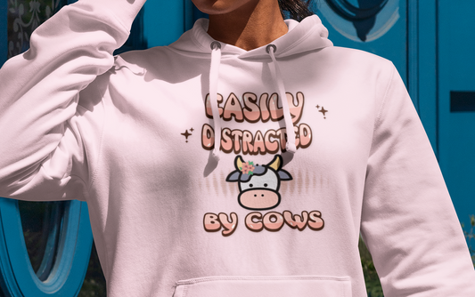 Easily Distracted by Cows Hoodie – Funny Farm Graphic Sweatshirt, Cow Lover Unisex Pullover Printify Hoodie Nordic Seoul Designs LLC